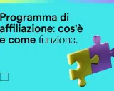 Programma di affiliazione: cos'è e come funziona. Due pezzi di puzzle, uno giallo e uno viola, si uniscono, simboleggiando la collaborazione.